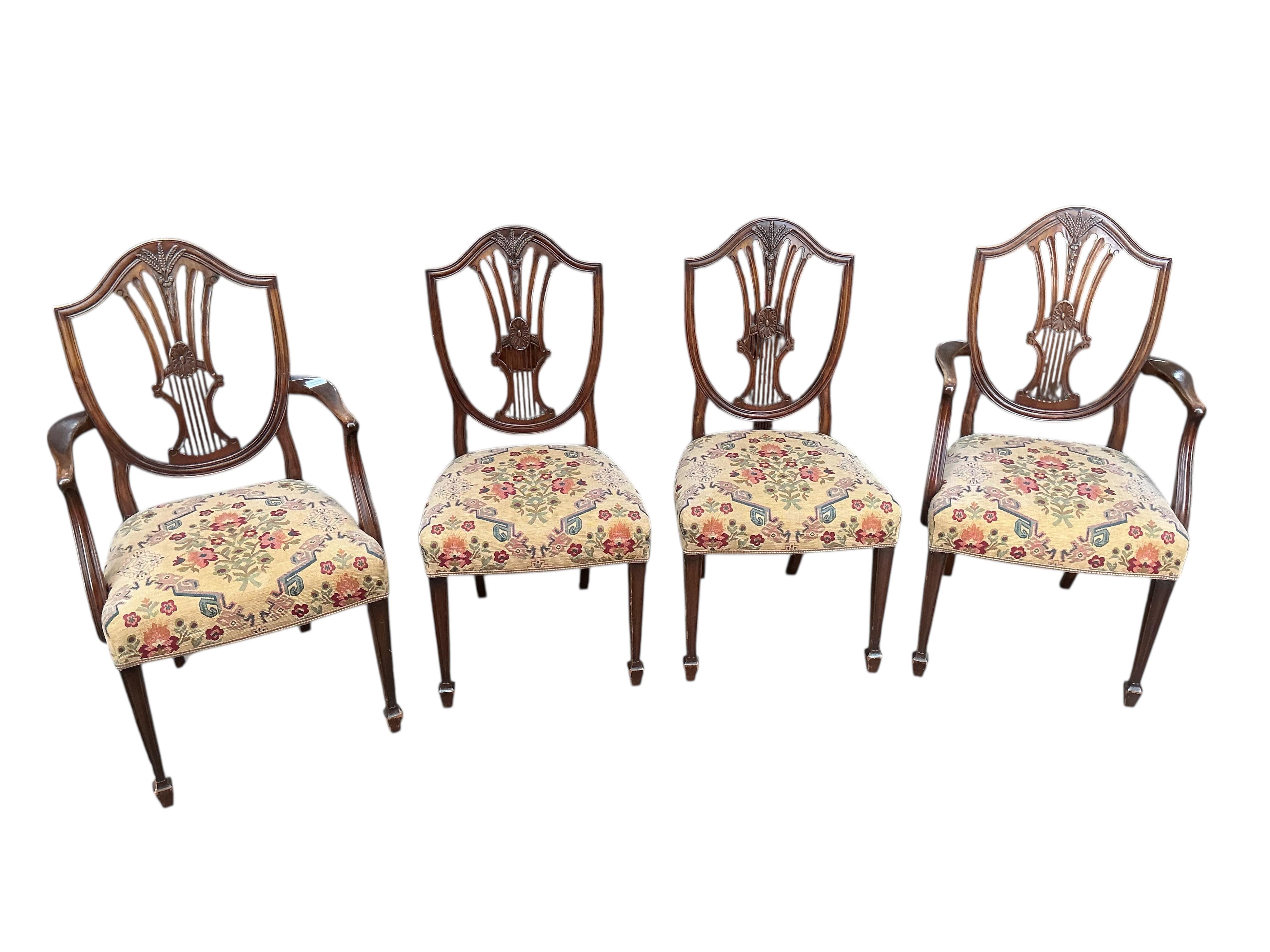 A set of eight George III style mahogany shield back dining chairs, two with arms